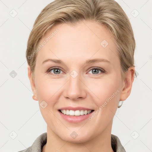 Joyful white young-adult female with short  brown hair and grey eyes