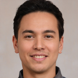 Joyful white young-adult male with short  black hair and brown eyes