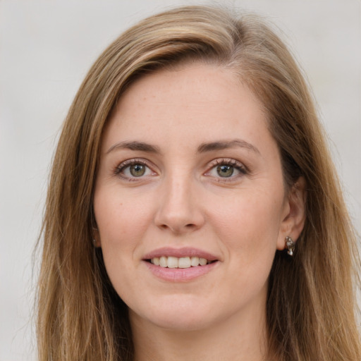 Joyful white young-adult female with long  brown hair and green eyes