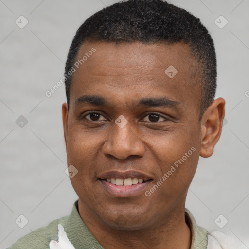 Joyful black young-adult male with short  black hair and brown eyes