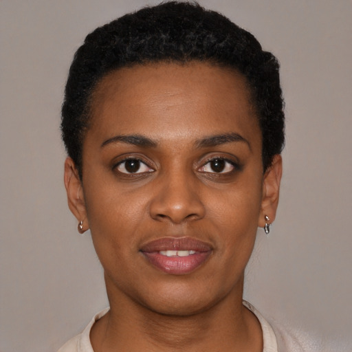 Joyful black young-adult female with short  brown hair and brown eyes