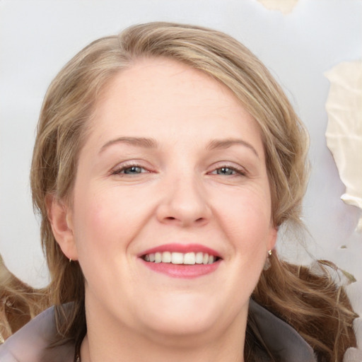 Joyful white adult female with medium  brown hair and blue eyes