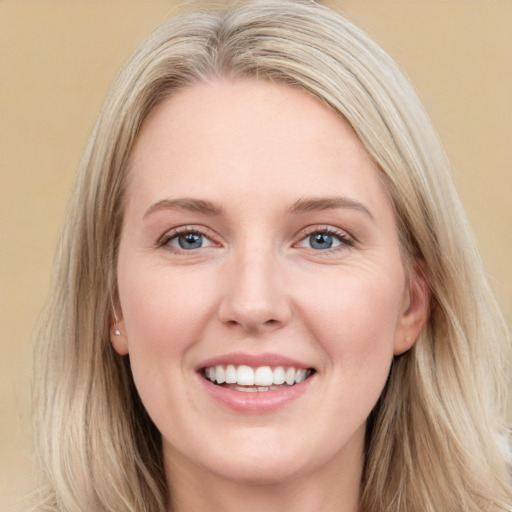 Joyful white young-adult female with long  brown hair and blue eyes