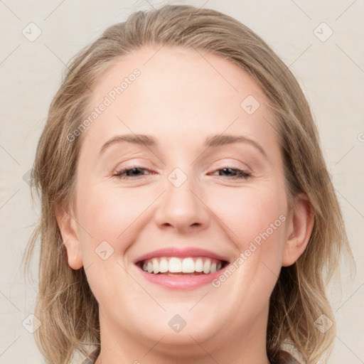 Joyful white young-adult female with medium  brown hair and blue eyes