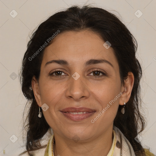 Joyful latino adult female with medium  brown hair and brown eyes