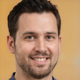 Joyful white adult male with short  brown hair and brown eyes