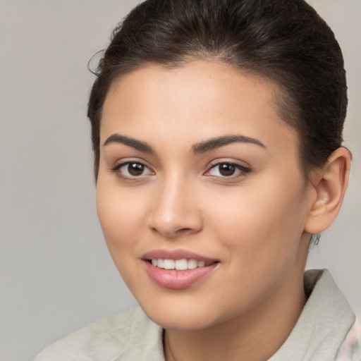 Joyful white young-adult female with long  brown hair and brown eyes