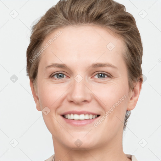 Joyful white young-adult female with short  brown hair and grey eyes