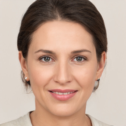 Joyful white young-adult female with medium  brown hair and brown eyes