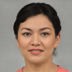 Joyful asian young-adult female with short  black hair and brown eyes