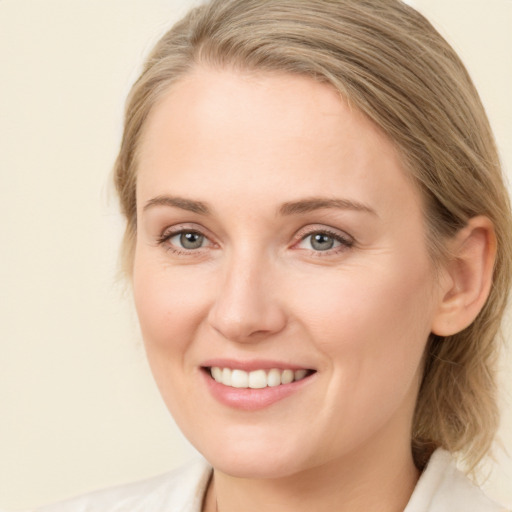 Joyful white young-adult female with medium  brown hair and green eyes