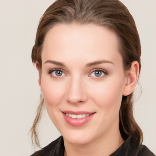 Joyful white young-adult female with medium  brown hair and grey eyes