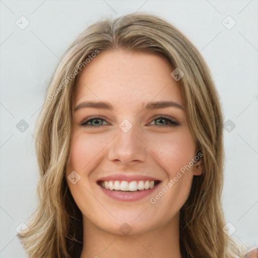 Joyful white young-adult female with long  brown hair and green eyes