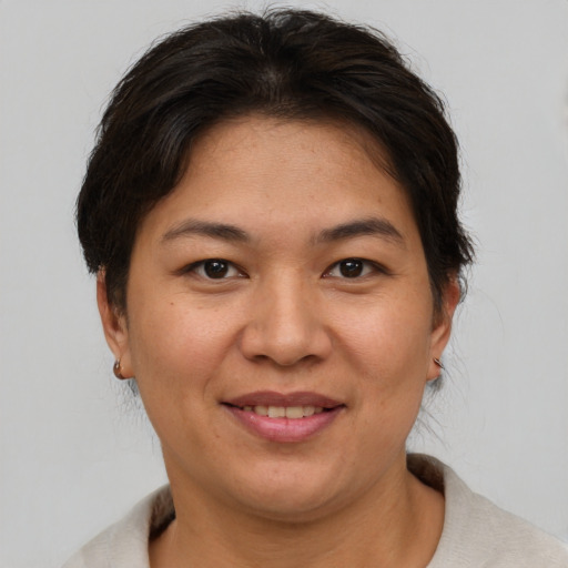 Joyful asian adult female with short  brown hair and brown eyes