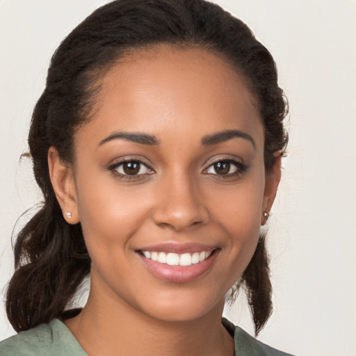 Joyful latino young-adult female with long  brown hair and brown eyes