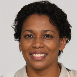 Joyful black adult female with short  brown hair and brown eyes