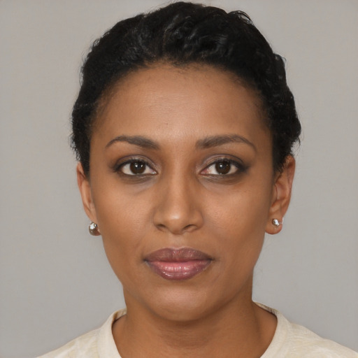 Joyful latino young-adult female with short  black hair and brown eyes