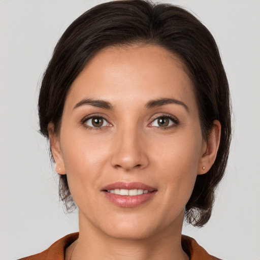 Joyful white young-adult female with medium  brown hair and brown eyes