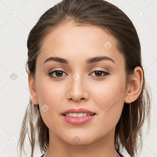 Joyful white young-adult female with long  brown hair and brown eyes