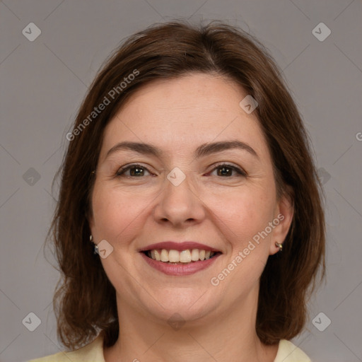 Joyful white adult female with medium  brown hair and brown eyes