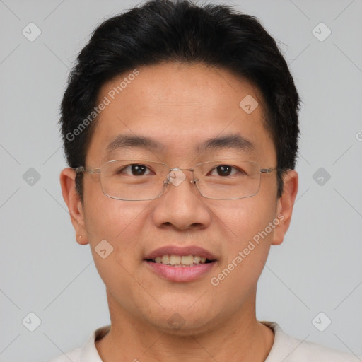 Joyful asian adult male with short  brown hair and brown eyes