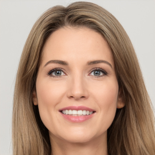 Joyful white young-adult female with long  brown hair and brown eyes