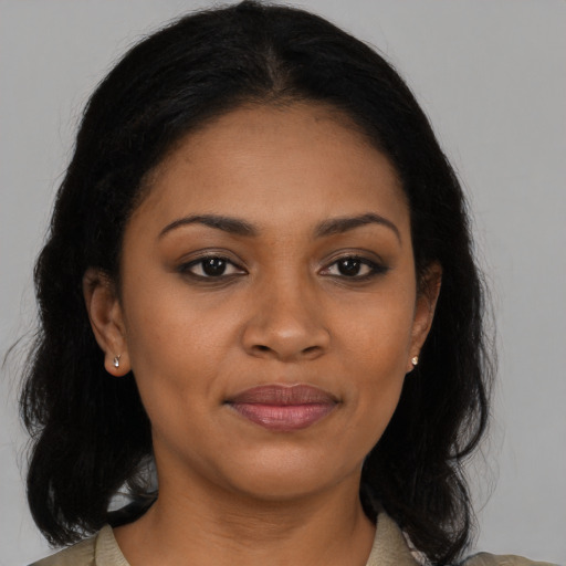 Joyful black young-adult female with medium  brown hair and brown eyes