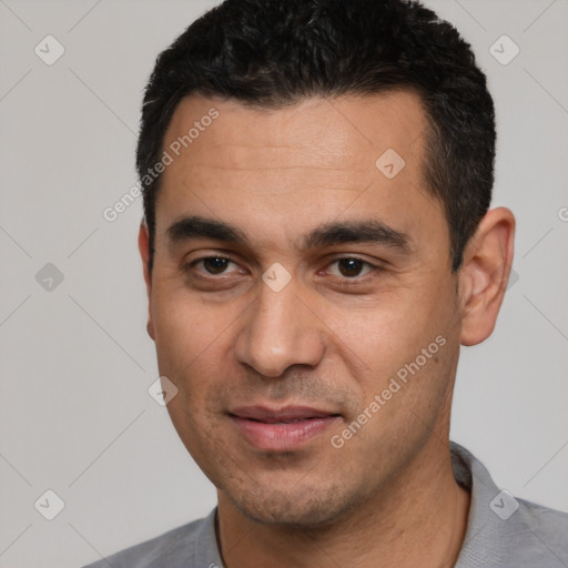 Joyful white young-adult male with short  black hair and brown eyes