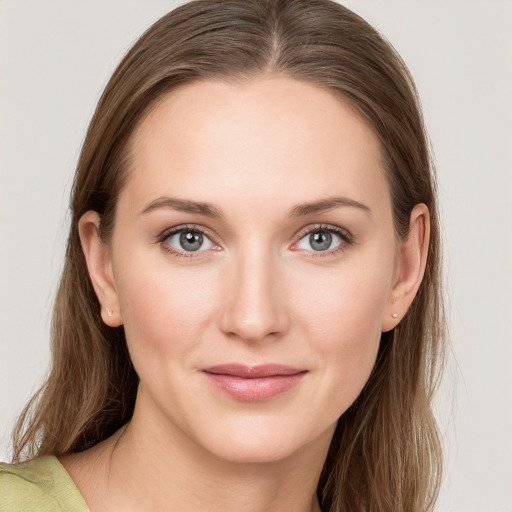 Joyful white young-adult female with long  brown hair and grey eyes