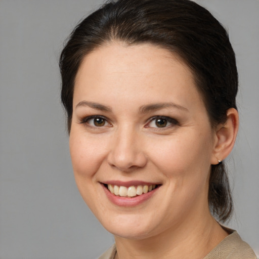 Joyful white young-adult female with medium  brown hair and brown eyes