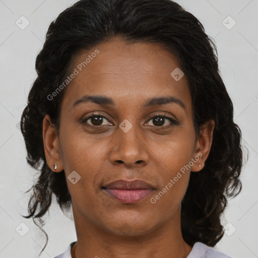 Joyful black adult female with medium  brown hair and brown eyes