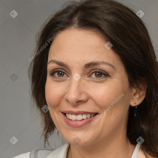 Joyful white adult female with medium  brown hair and brown eyes