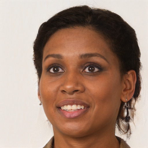 Joyful black young-adult female with medium  brown hair and brown eyes