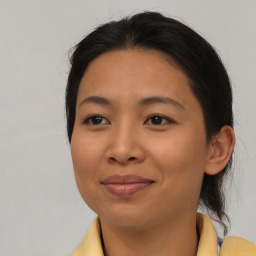 Joyful asian young-adult female with medium  brown hair and brown eyes