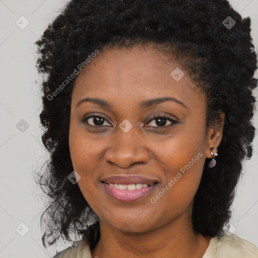 Joyful black young-adult female with long  brown hair and brown eyes