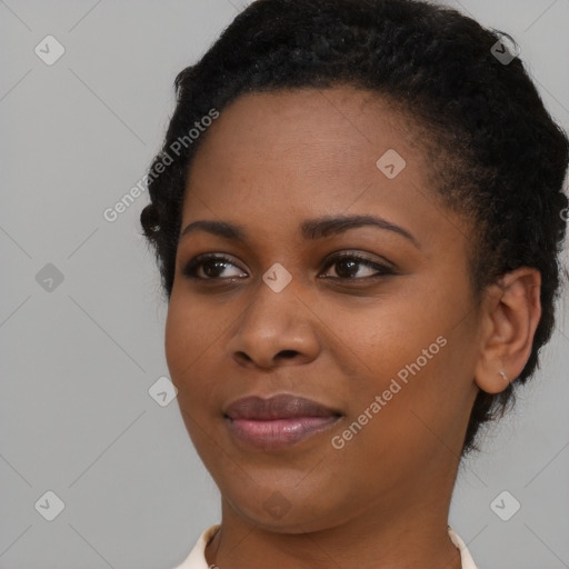 Joyful black young-adult female with short  black hair and brown eyes