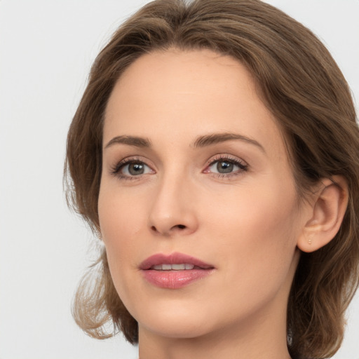 Joyful white young-adult female with medium  brown hair and green eyes