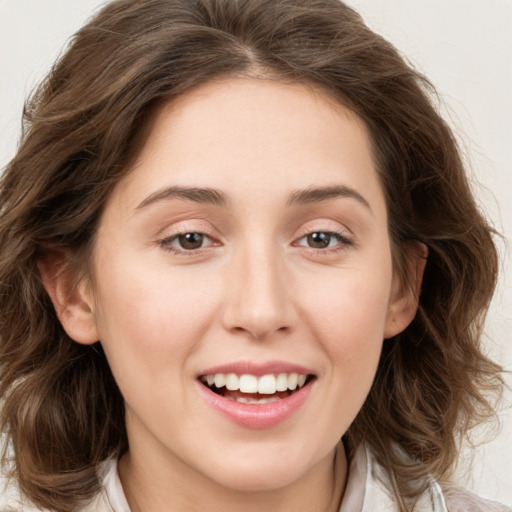 Joyful white young-adult female with medium  brown hair and green eyes