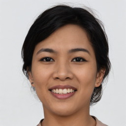 Joyful asian young-adult female with medium  black hair and brown eyes