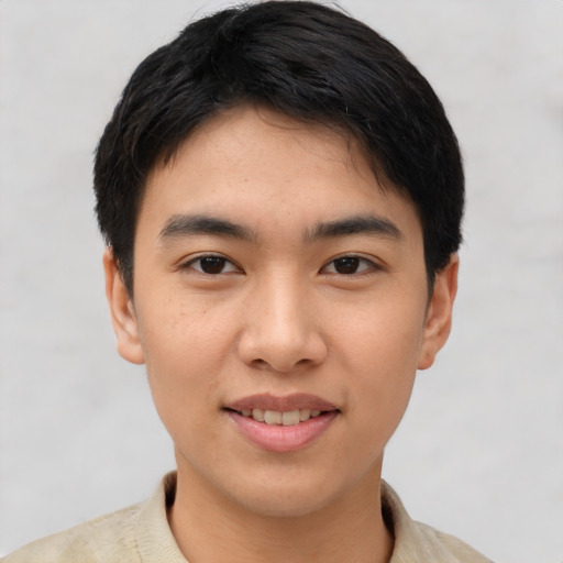 Joyful asian young-adult male with short  black hair and brown eyes