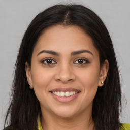 Joyful latino young-adult female with long  brown hair and brown eyes