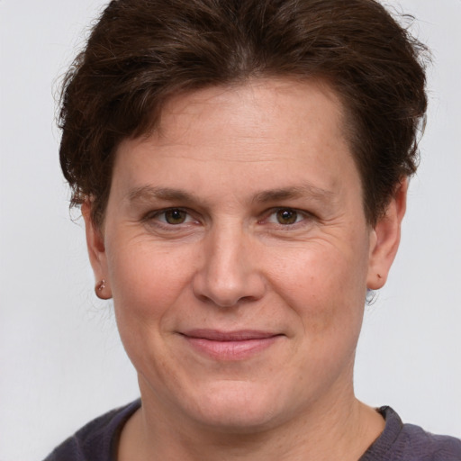 Joyful white adult female with short  brown hair and brown eyes