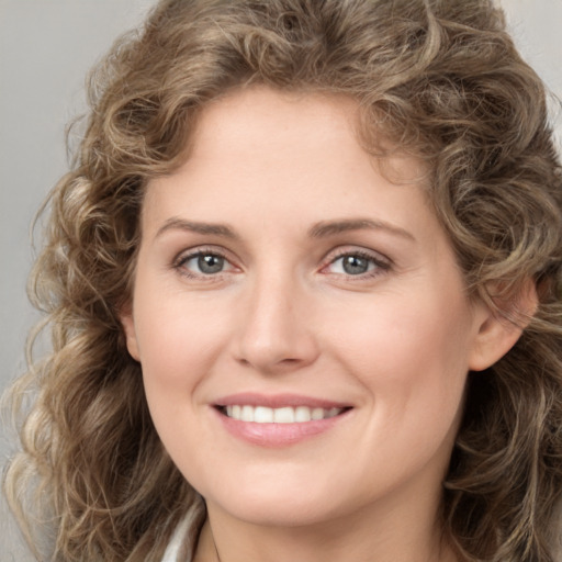 Joyful white young-adult female with medium  brown hair and green eyes