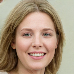 Joyful white young-adult female with medium  brown hair and green eyes