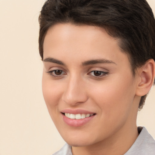 Joyful white young-adult female with short  brown hair and brown eyes