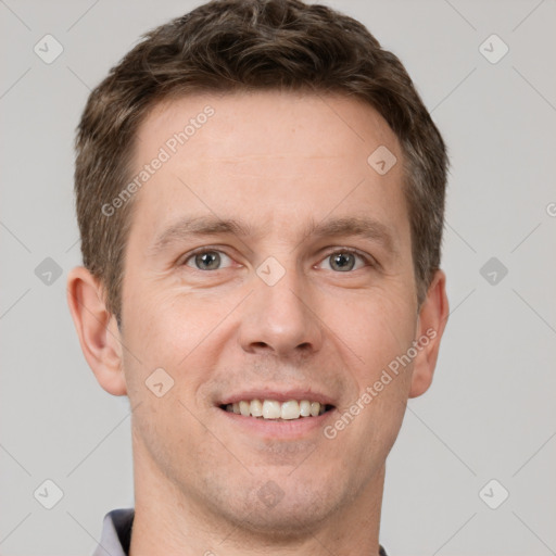 Joyful white adult male with short  brown hair and grey eyes