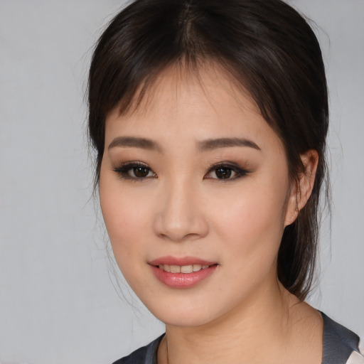 Joyful asian young-adult female with medium  brown hair and brown eyes