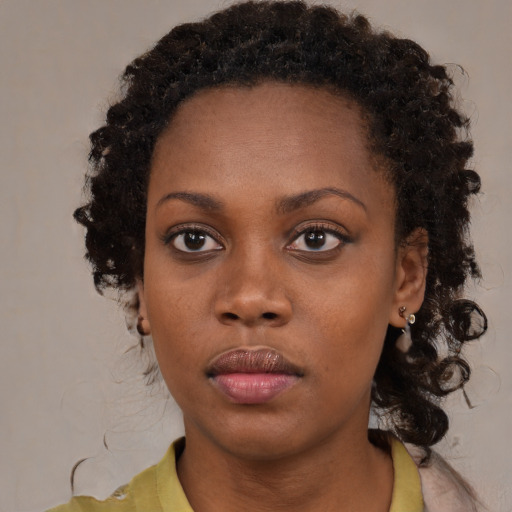 Neutral black young-adult female with medium  brown hair and brown eyes