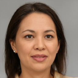 Joyful white adult female with medium  brown hair and brown eyes