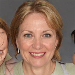 Joyful white adult female with medium  brown hair and blue eyes